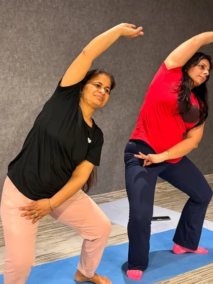 In my classes, we explore graceful movements that combine stretching and strength. Here, my students are practicing a side bend variation, which is excellent for improving spinal flexibility and toning the waistline.