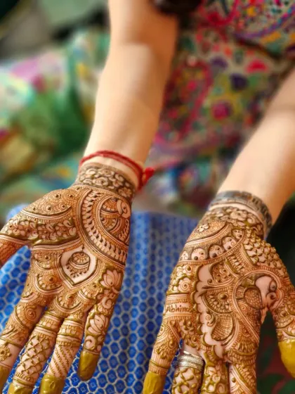 A more detailed design for a close family member of the bride. The palms are filled with traditional Indian patterns, including a hidden name 'Abhinav'.