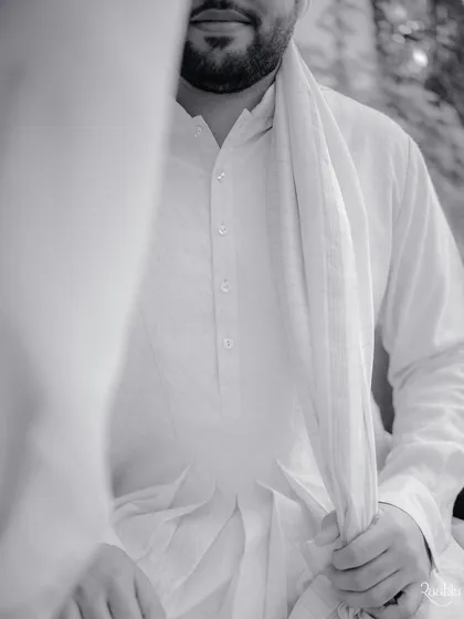 The quiet calm before the baraat. This black and white portrait of the groom, Manan, captures a moment of introspection and anticipation.