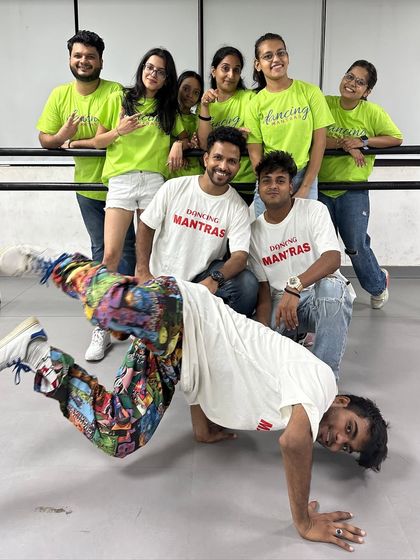 The "RULE Breakers" team showing off their skills, with one member in a cool breakdance pose. This photo captures their dynamic and versatile talent.