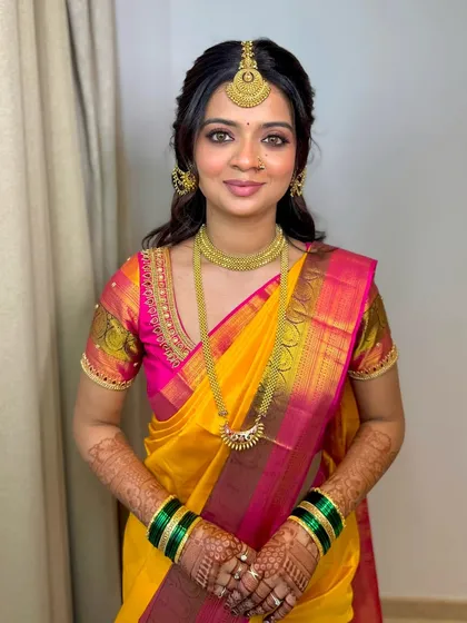 It's all in the eye makeup. For this stunning Shetty bride, I created a look with gorgeous nude shades and finely detailed eye makeup to complement her vibrant yellow and pink Kanjeevaram saree.