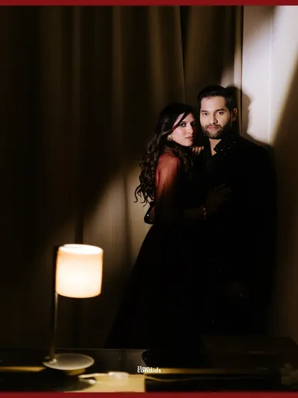 A moody, intimate portrait of the couple in a quiet corner during their reception. The dramatic lighting creates a cinematic, romantic feel.