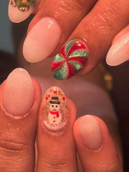 A close-up of the tiny, hand-painted snowman inside a snow globe and the glittery candy swirl. It's all in the little details!