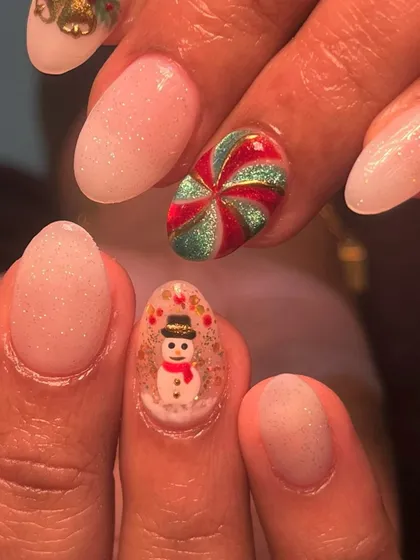 A close-up of the tiny, hand-painted snowman inside a snow globe and the glittery candy swirl. It's all in the little details!