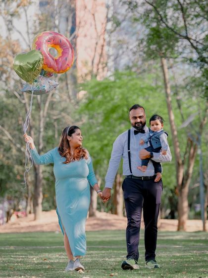 A family strolls through the park with celebratory balloons, marking a special occasion. I incorporate props naturally to add a personal touch to your photos.