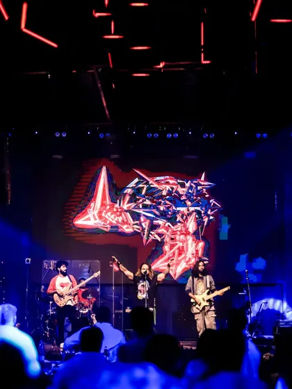 The full band in our element, lighting up a massive stage. We bring a full-scale rock concert production and sound to your private event.