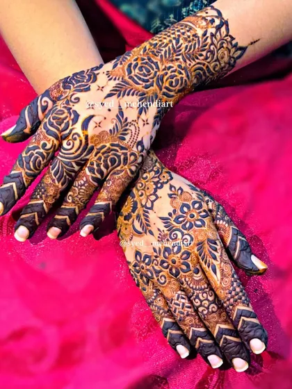 A beautiful party-wear design with asymmetrical patterns, one hand featuring roses and the other with more traditional motifs.