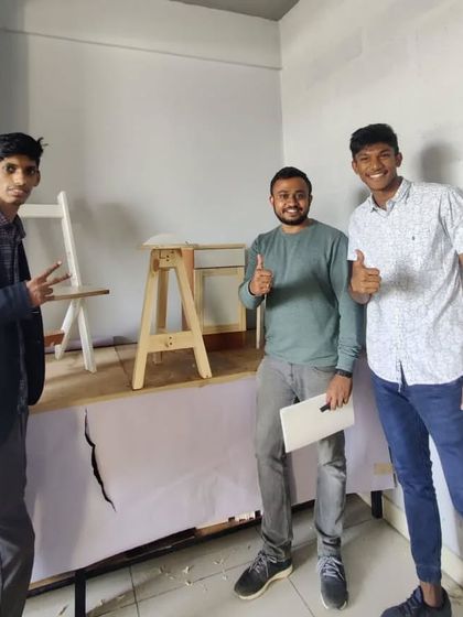 Three students from the Bangalore School of Design workshop, proud of the chair and stool they built.