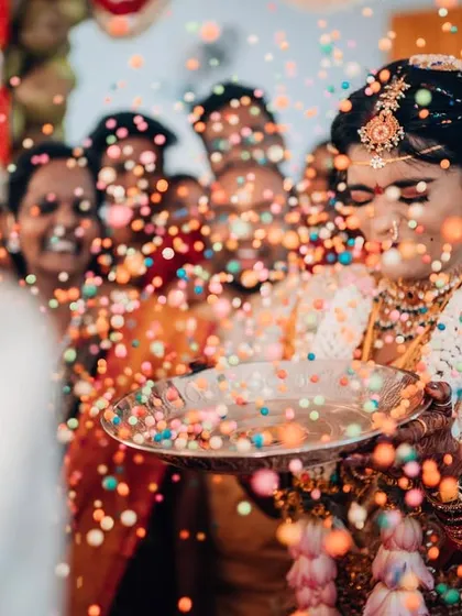 The pure, unscripted joy of a wedding ritual. We live for these candid moments, capturing the vibrant colors and infectious laughter that make your celebration truly unforgettable.