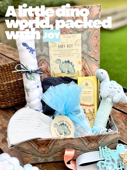 I call this one "A little dino world, packed with joy." This baby boy hamper brings a playful dinosaur theme to life with soft blue tones, a friendly dino rattle, and coordinated essentials, all presented in a beautiful marbled keepsake box.