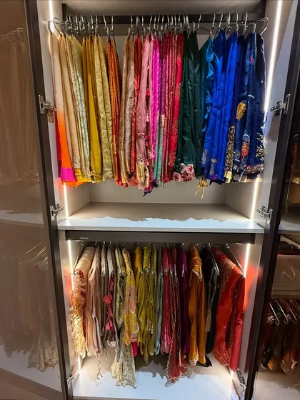 A rainbow of color in this festive wear closet. We organize by color and occasion, hanging delicate items to maintain their shape and beauty. The integrated lighting makes selecting the perfect outfit a delight.