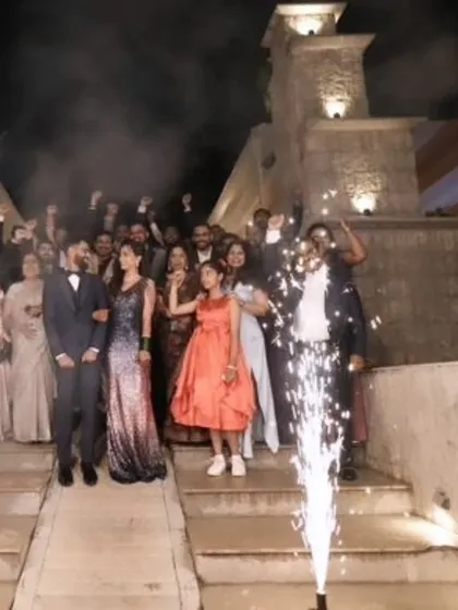 A grand entrance for a grand occasion. The bride and groom are surrounded by loved ones as she shines in her custom sequin mermaid gown.