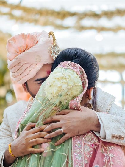 An intimate, close-up shot of the couple hugging tightly after their wedding ceremony, a moment of pure emotion.