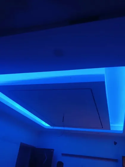 Another angle of the living room ceiling with vibrant blue LED lighting. The recessed design adds depth and a futuristic feel to the space.
