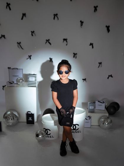 A powerful, centered pose from the older sister, looking straight at the camera like a true model.