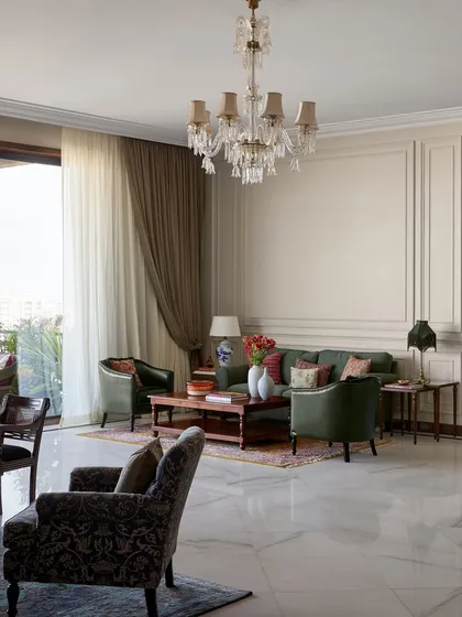 For the expansive central lounge at the new Maddock office, I chose to create several intimate seating areas instead of one large one. This approach encourages smaller, more personal conversations, turning a large hall into a series of warm, inviting corners for creative collaboration, all anchored by timeless wall paneling and a classic crystal chandelier.