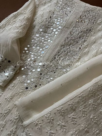 A detail shot of the sleeve and neckline, highlighting the density of the mirrorwork.