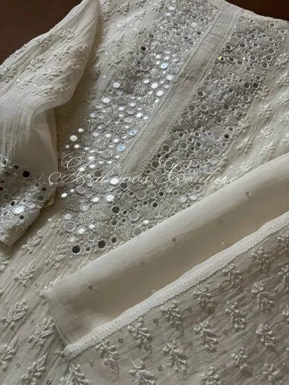 A detail shot of the sleeve and neckline, highlighting the density of the mirrorwork.