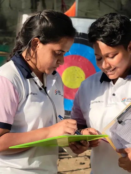 Two officials carefully checking the scores. Their expertise ensures that our competitions are fair and professional.