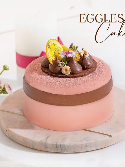 An eggless cake that compromises on nothing. This beautiful pink and brown entremet is a testament to our commitment to delicious desserts for everyone.