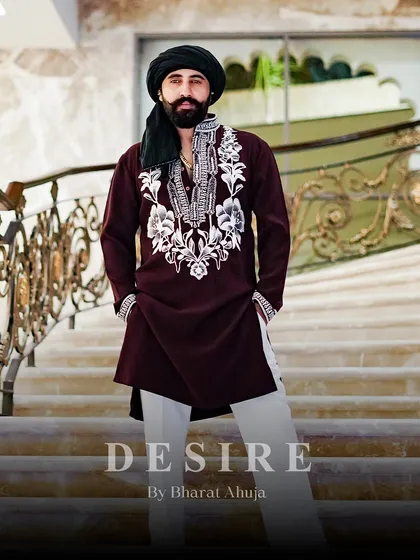 True style is about presence. I designed this deep maroon kurta with striking ivory embroidery on the neckline and cuffs to project an aura of quiet strength. Paired with classic trousers, it is a complete look of refined, masculine power for any celebration.