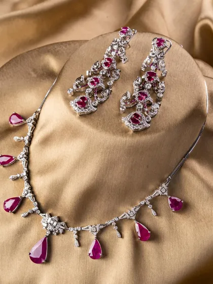 Our Scarlet Royale set, crafted with pear-shaped rubies and a mix of rose-cut and baguette diamonds. It has a classic, old-money charm with a modern edge.