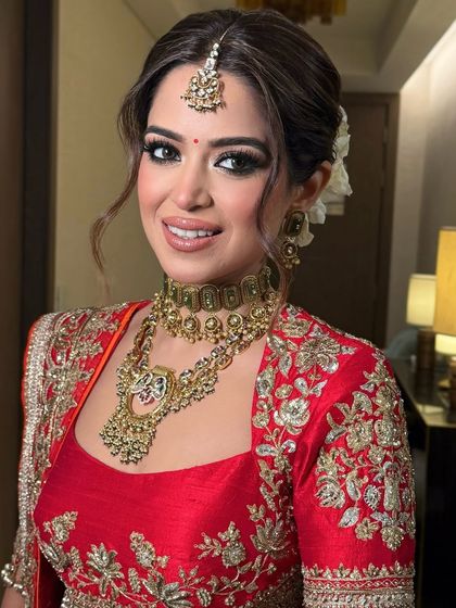 A beautiful bride with a classic low bun adorned with white roses, a timeless and elegant choice for a wedding day.