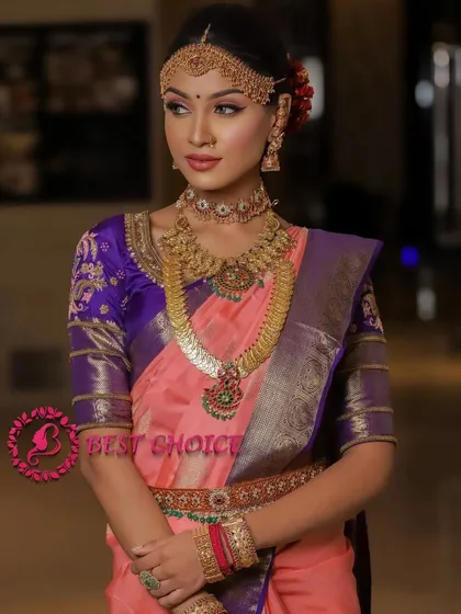 A full view of the model, showing how the layered coin necklaces and vaddanam create a stunning traditional silhouette.