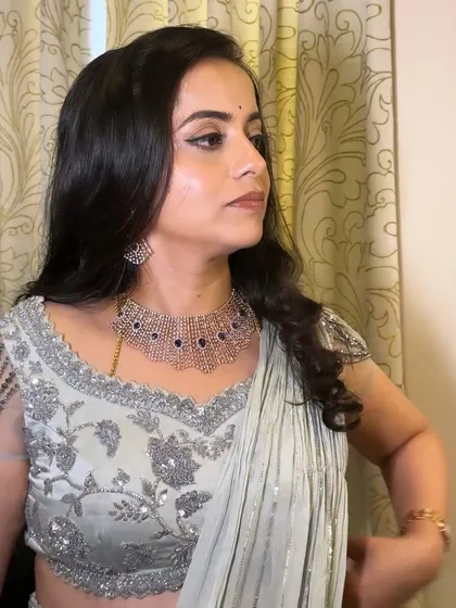 A side profile of the makeup, showing the clean lines of the eyeliner and the soft contouring on the cheeks.