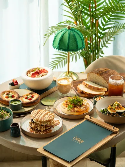A bright and sunny brunch layout. The natural light and green plant accents create a fresh and healthy atmosphere.