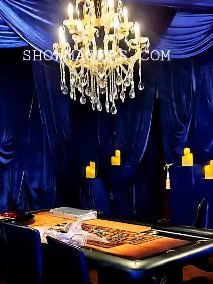 Another view of the casino table setup, showcasing the opulent ambiance created by the combination of rich fabrics and elegant lighting.