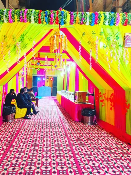 The entrance to a bright and colourful tent, designed to create a memorable first impression for guests arriving at the event.