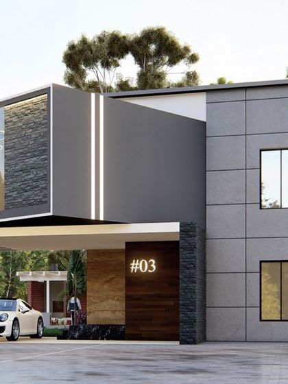 A frontal view of another modern home, where a cantilevered volume creates a covered car porch. The facade uses a mix of grey tiles, dark stone, and wood accents for a sophisticated urban look.