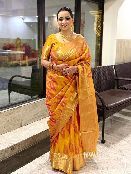 Simple and pretty. This client looks so elegant in her yellow and pink silk saree, paired with a clean makeup look and a traditional bun.