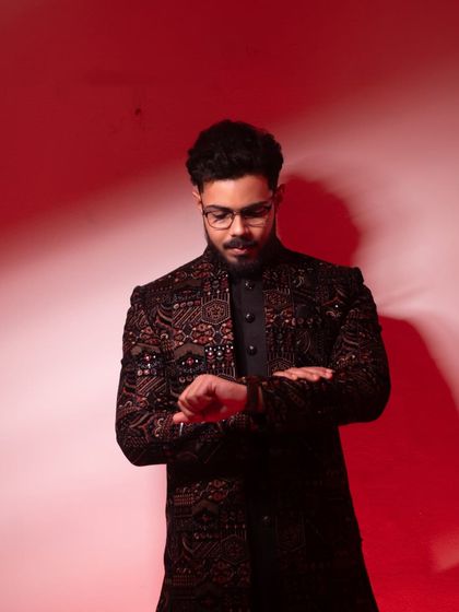 A candid moment as the groom checks the time, a classic pose that adds a touch of storytelling and anticipation to the wedding album.