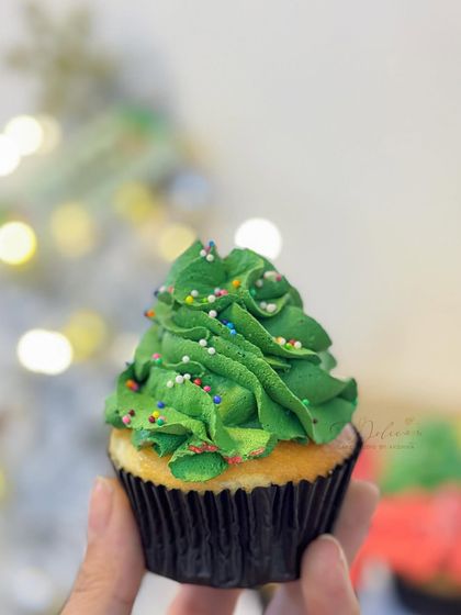 Another shot of the Christmas tree cupcake. It’s a simple vanilla cupcake with buttercream frosting, a perfect little bite of holiday cheer.
