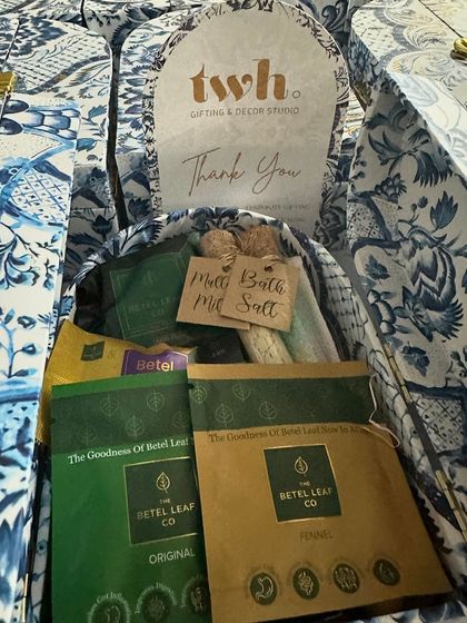 Inside our blue and white floral "Thank You" boxes. We included unique local products like The Betel Leaf Co. tea, making it a memorable and distinctly Indian gift.