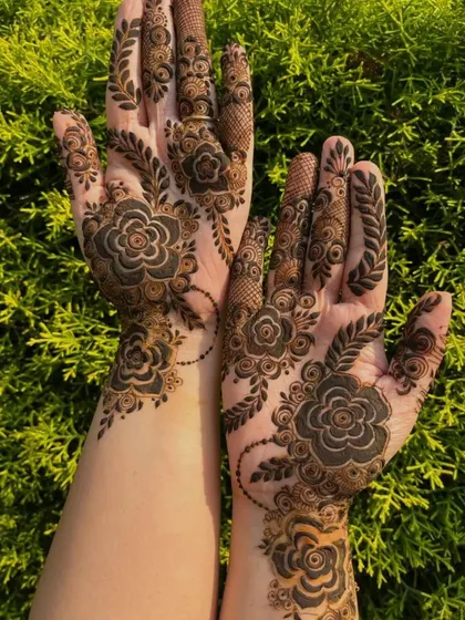An example of a modern, bold floral design. This style uses negative space to make the dark henna pop, perfect for someone who wants a statement look that isn't as dense as traditional bridal mehendi.