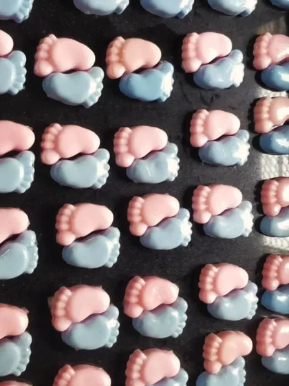 The baby feet soaps before packaging, showing the two-tone pink and blue design.