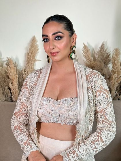 A soft glam look with bold eyes for Lakmé Fashion Week. The makeup is designed to be flawless and long-lasting for the event.