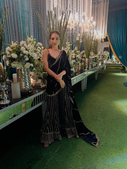 For a wedding sangeet, I chose this stunning navy blue velvet sharara set. The intricate gold embroidery and rich fabric make it a perfect choice for an evening of music and dance.