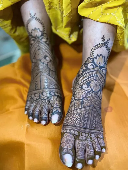 An intricate design for the bride's feet, featuring a combination of floral and geometric patterns that extend from the ankle to the toes.
