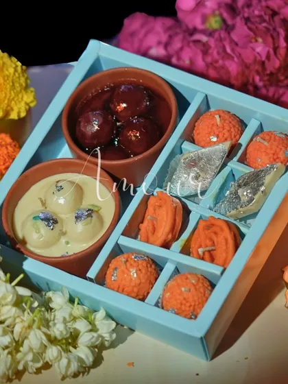 A complete box of sweet treats that are actually candles. This set includes Gulab Jamun and Rasgulla bowl candles alongside Laddoo, Jalebi, and Kaju Katli candles for the ultimate festive vibe.