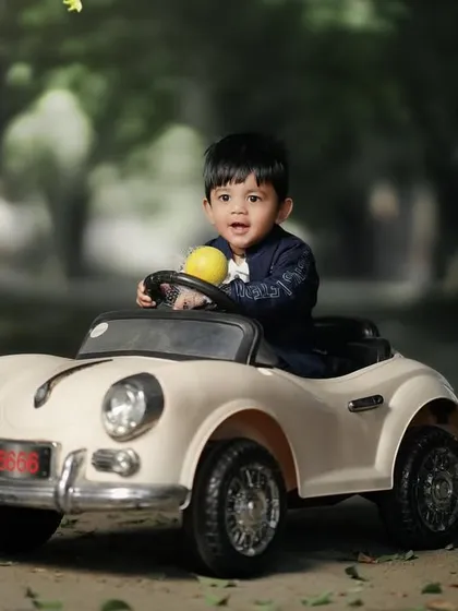 A happy driver with a little yellow ball. It's the small, playful details that make these sessions so special and unique to each child.