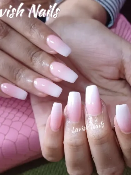 A beautifully executed soft ombré design, blending from a natural pink base to a crisp white tip on long, coffin-shaped nails for a subtle and modern bridal look.