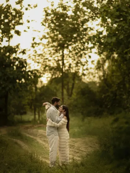 An intimate embrace in the heart of the woods. This photo showcases a quiet, loving moment between the couple, surrounded by the beauty and tranquility of nature.