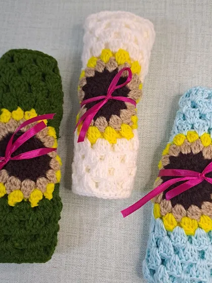 I package my sunflower sling bags with a ribbon, making them ready for gifting. Here are three different color options rolled up and ready to go.