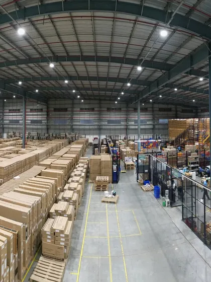 Another panoramic view of the Croma warehouse, capturing the height of the storage racks and the organized chaos of a busy distribution center.
