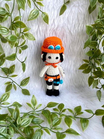 Ace from One Piece! I love creating anime characters because they are so unique and let me be creative. This doll features his signature hat, tattoos, and accessories.