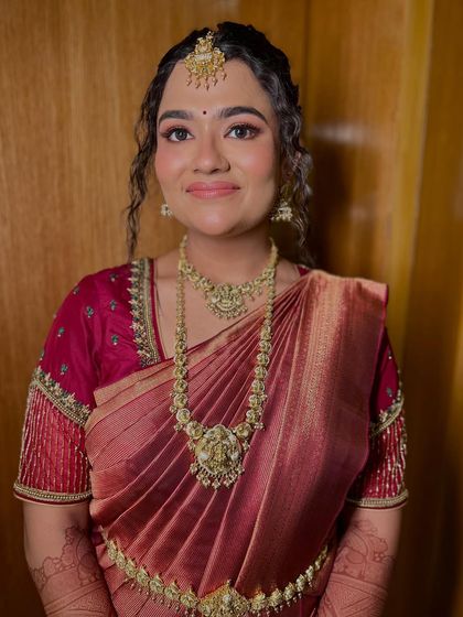 My bride Sowmya, glowing with grace in her soft glam look, perfectly complemented by her traditional saree and jewelry.